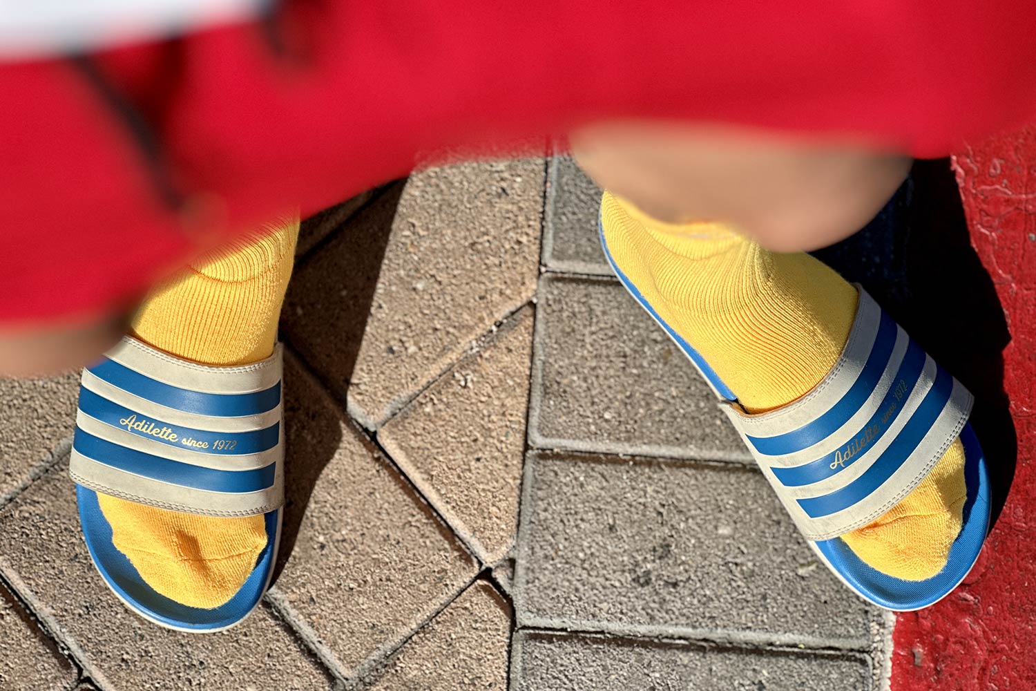 blue slides and orange socks